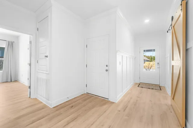 a view of hallway with wooden floor