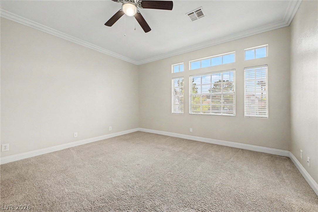 2316 Ramsgate Drive Henderson, NV 89074 - Photo 18 of 28 Well-lit living area with crown molding and ceiling fan offers a comfortable atmosphere.