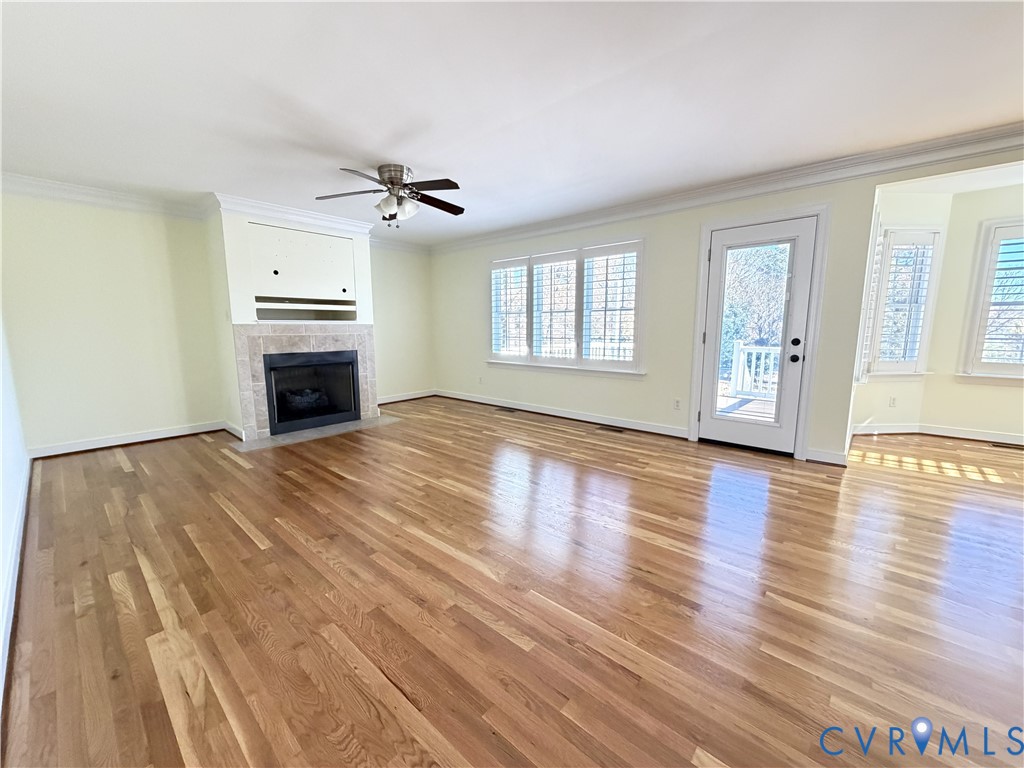 10911 Weybridge Road Chester, VA 23831 - Photo 15 of 38 an empty room with wooden floor ceiling fan and windows