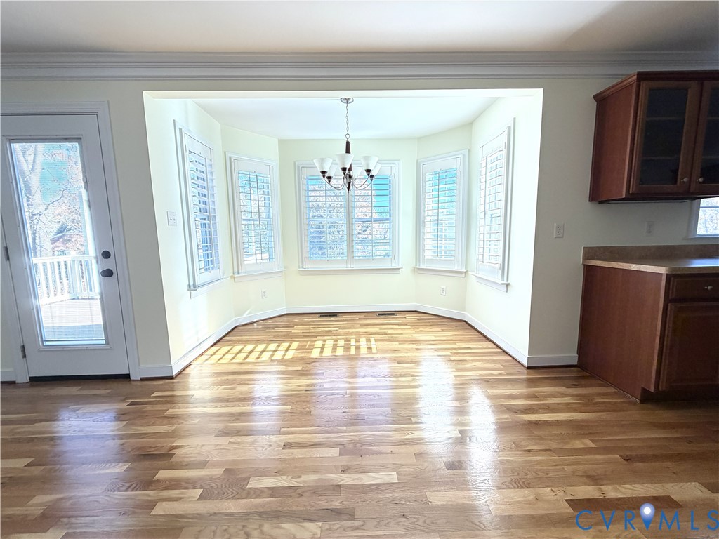 10911 Weybridge Road Chester, VA 23831 - Photo 16 of 38 a view of empty room with wooden floor and fan