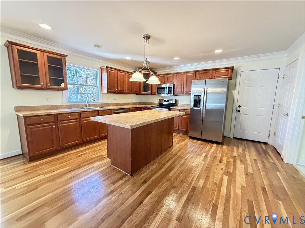 10911 Weybridge Road Chester, VA 23831 - Photo 19 of 38 a kitchen with wooden cabinets and stainless steel appliances
