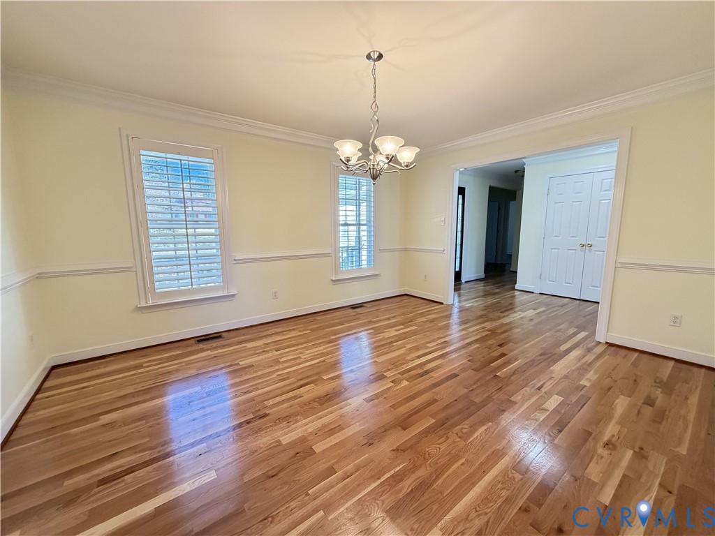 10911 Weybridge Road Chester, VA 23831 - Photo 25 of 38 a view of a room with wooden floor and chandelier