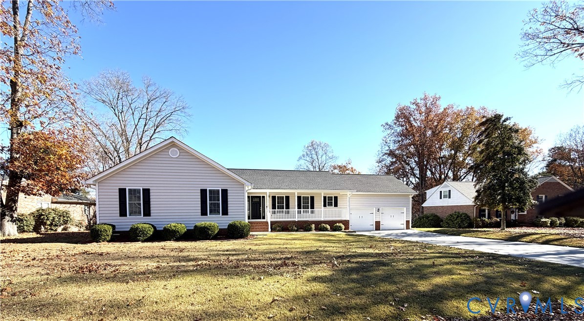 10911 Weybridge Road Chester, VA 23831 - Photo 4 of 38 a front view of a house with a yard