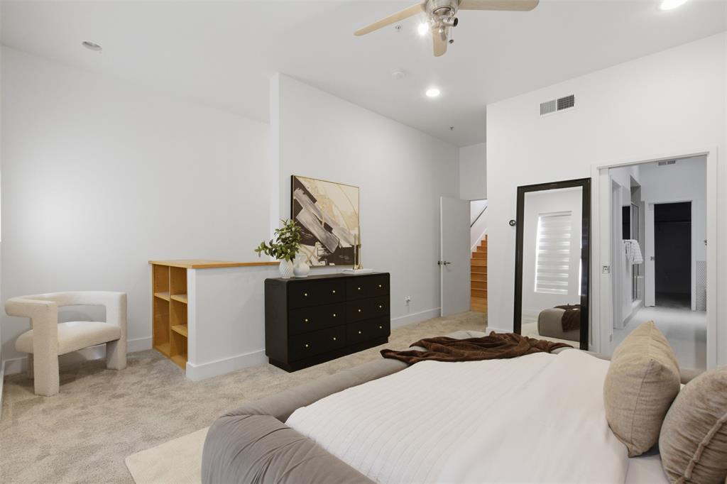 2111 Clark Street, Unit H Dallas, TX 75204 - Photo 9 of 37 a bedroom with a bed and a dresser
