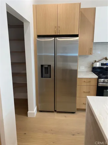 a kitchen with granite countertop a refrigerator and a stove