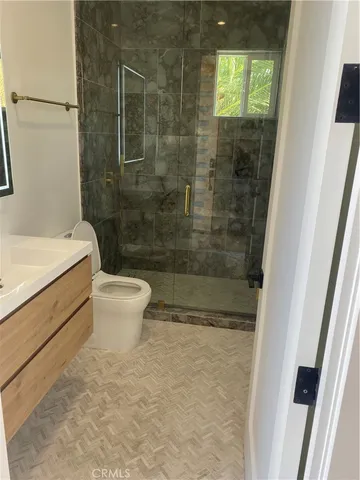 a bathroom with a white toilet sitting next to a shower