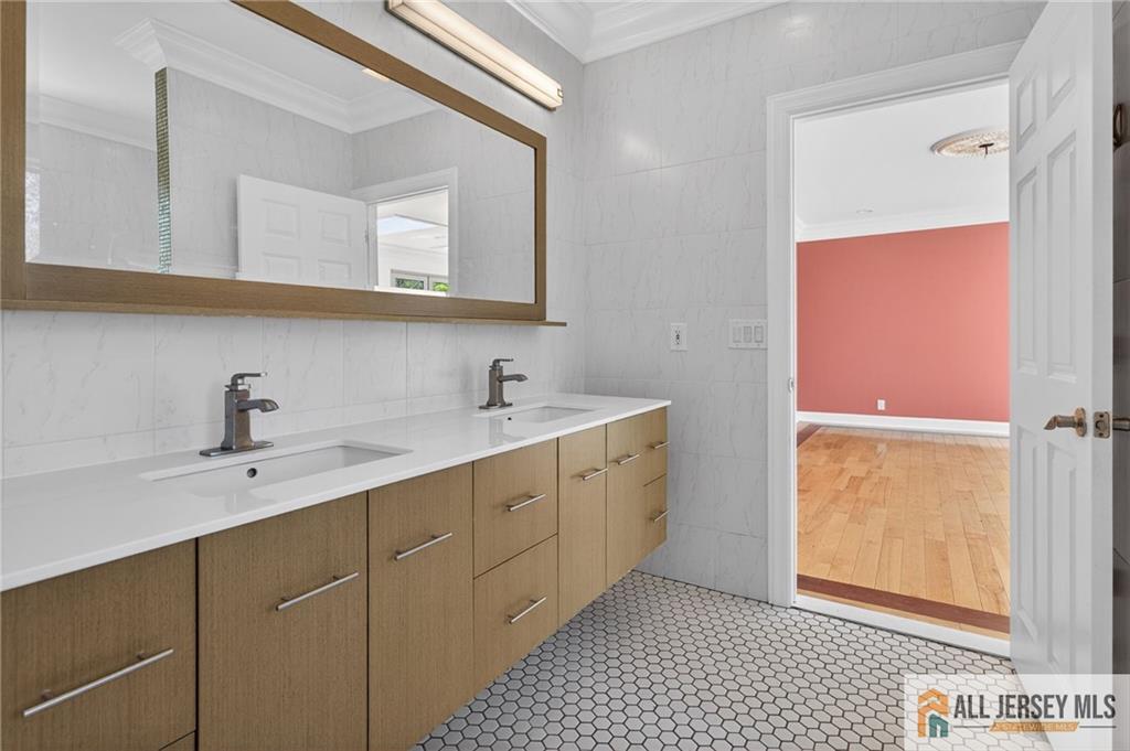381 Monmouth Road Freehold, NJ 07728 - Photo 33 of 63 a bathroom with a sink a mirror and a shower