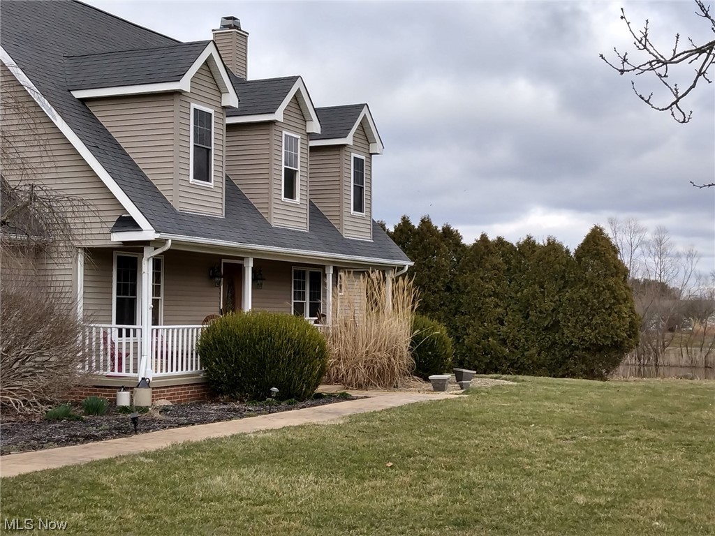 1755 Fixler Road Wadsworth, OH 44281 - Photo 3 of 12 View of front of property featuring a porch and a front yard