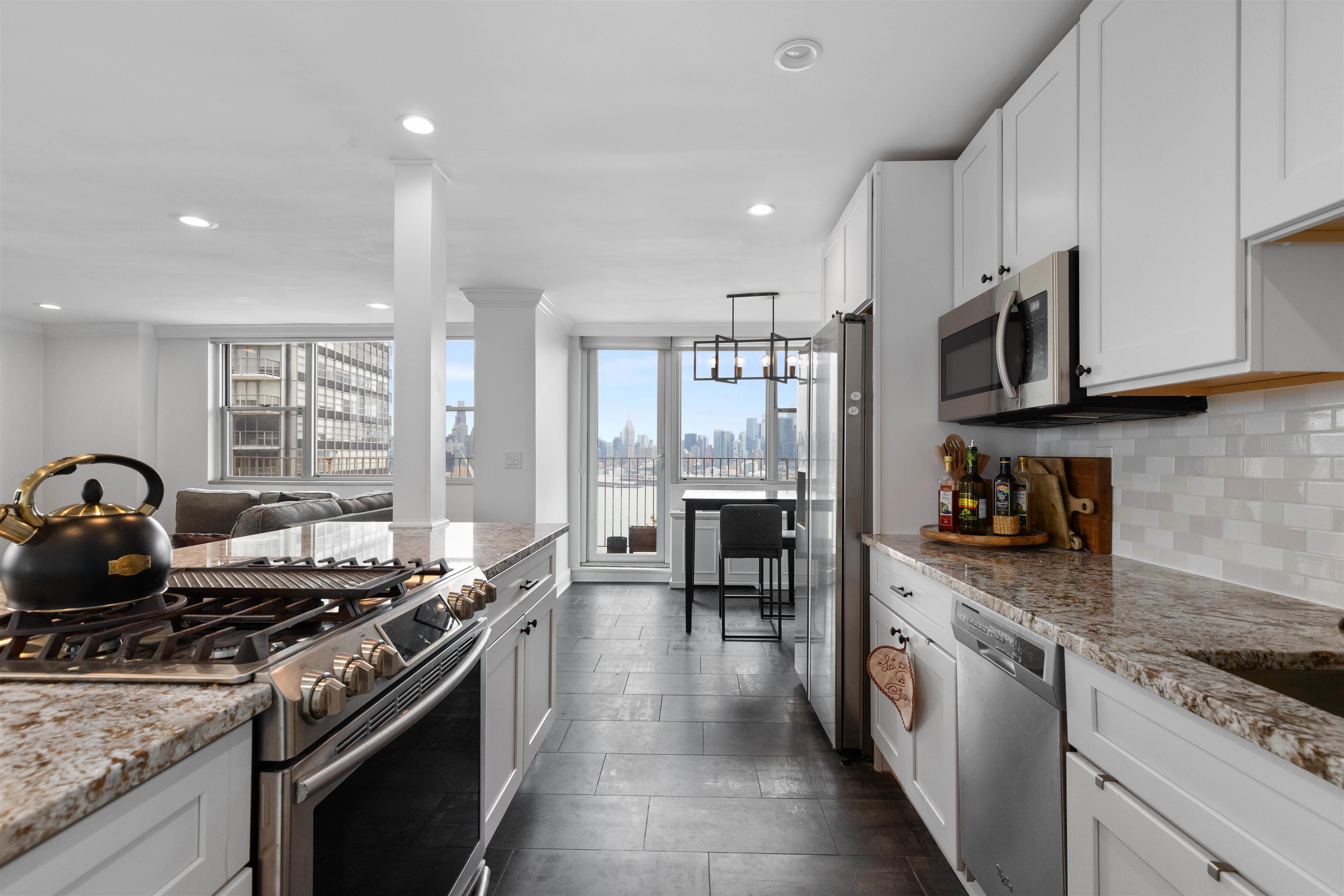a kitchen with stainless steel appliances granite countertop a stove and a sink