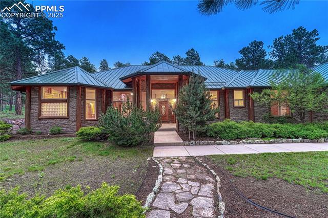 15975 Winding Trail Road Colorado Springs, CO 80908 - Photo 6 of 50 Dramatic covered front entrance