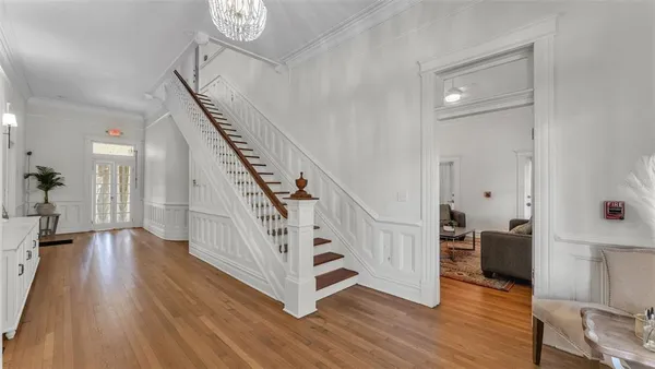 a view of entryway and hall with wooden floor