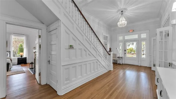a view of a hallway view with wooden floor and staircase