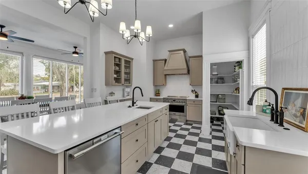 a kitchen with stainless steel appliances a sink stove and refrigerator