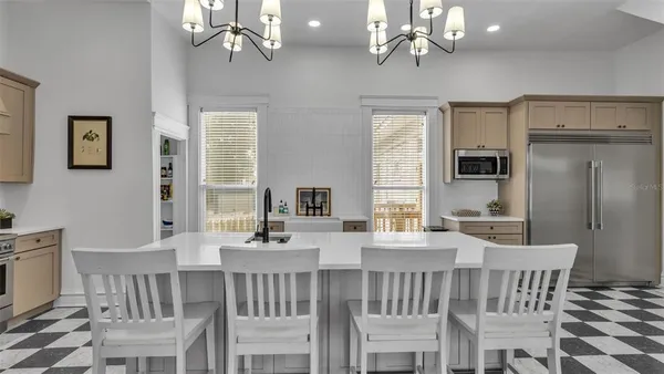 a view of a dining room with furniture a chandelier and wooden floor