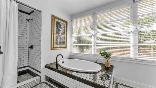 a bathroom with a granite countertop sink and a window