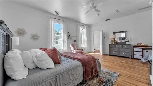 a view of a porch with wooden floor and windows