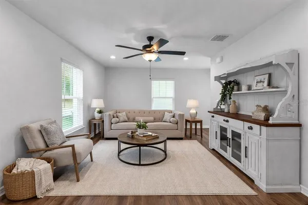a living room with furniture and a wooden floor