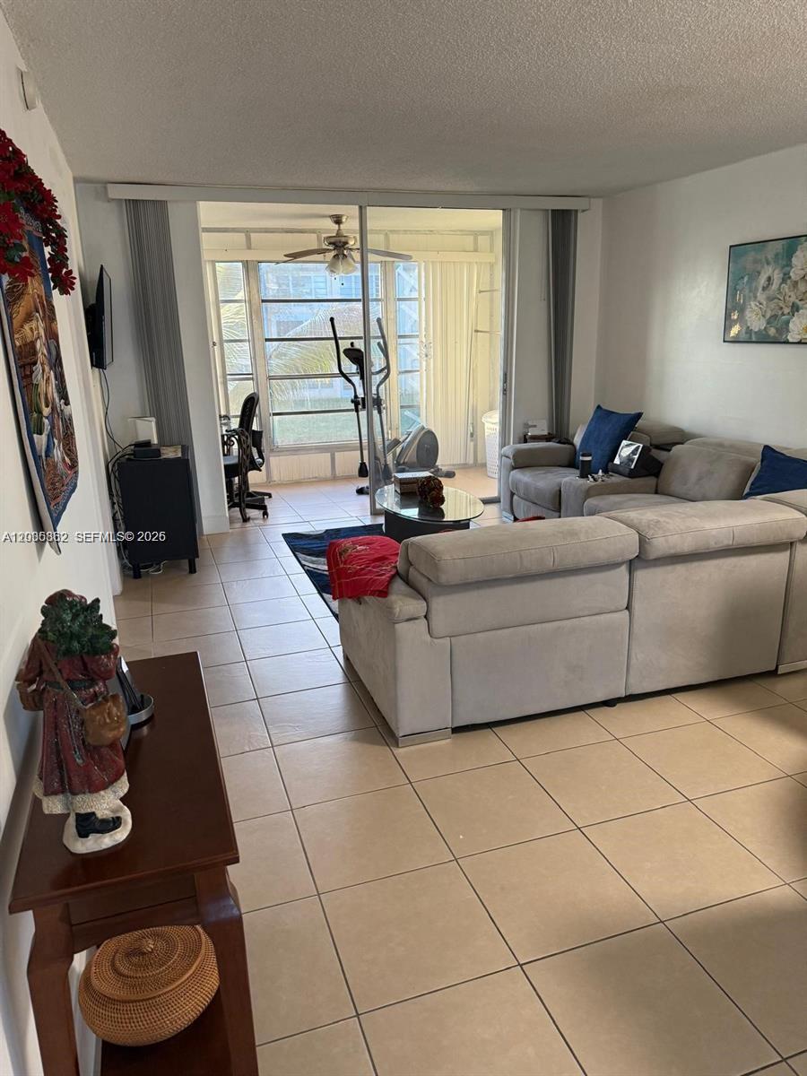 2900 North Pine Island Road, Unit 209 Sunrise, FL 33322 - Photo 6 of 14 a living room with furniture and a window