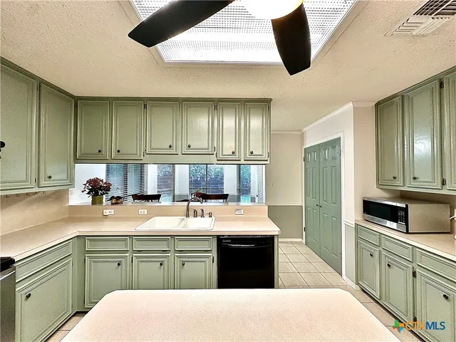 a bathroom with a tub sink shower and mirror