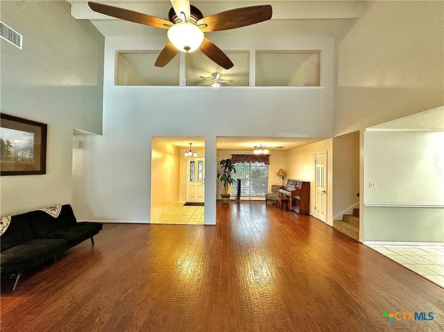 a living room with furniture and wooden floor