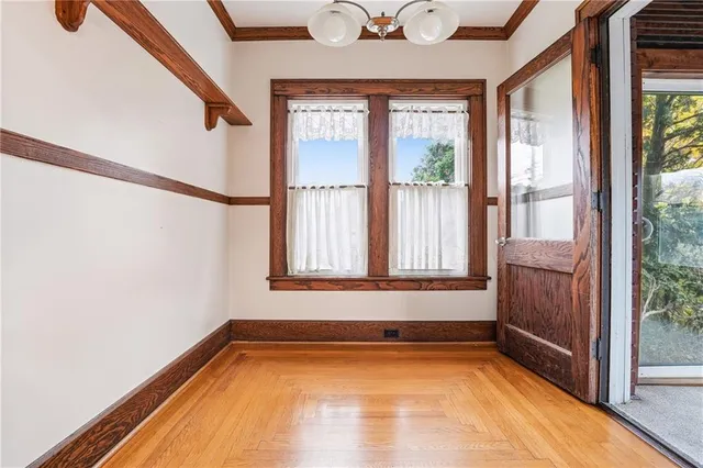 a view of a room with window and wooden floor