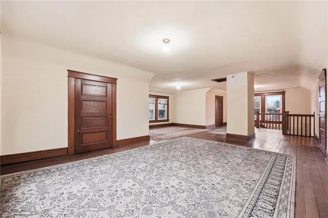 a view of a livingroom with wooden floor and a rug