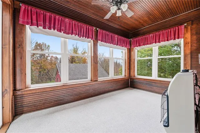 a view of a room with furniture and large windows