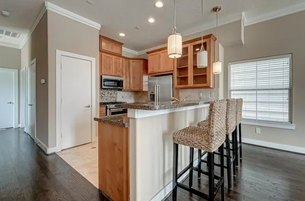 a kitchen with a table chairs refrigerator and microwave