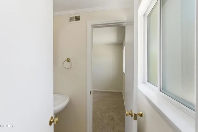 a bathroom with a toilet and mirror