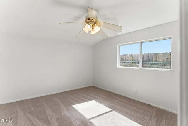 a very nice looking room with a chandelier fan and a window