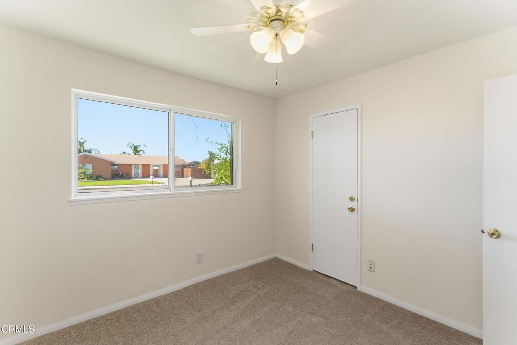 1290 Lawrence Circle Simi Valley, CA 93065 - Photo 21 of 37 an empty room with wooden floor a ceiling fan and windows