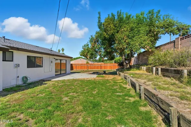 a view of a backyard with sitting area
