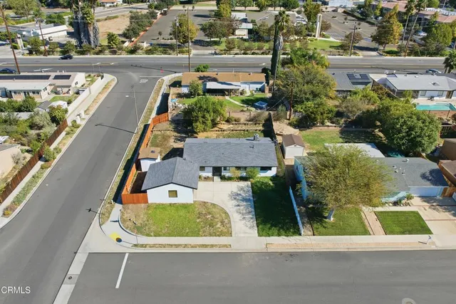 an aerial view of a house with a garden and plants