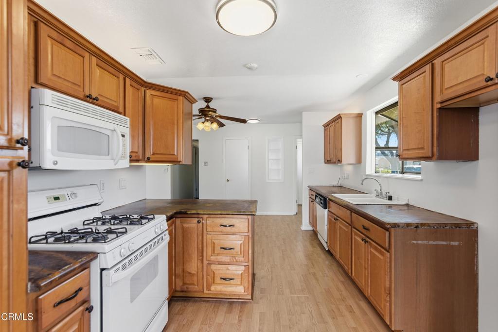 1290 Lawrence Circle Simi Valley, CA 93065 - Photo 6 of 37 a kitchen that has a sink and a stove
