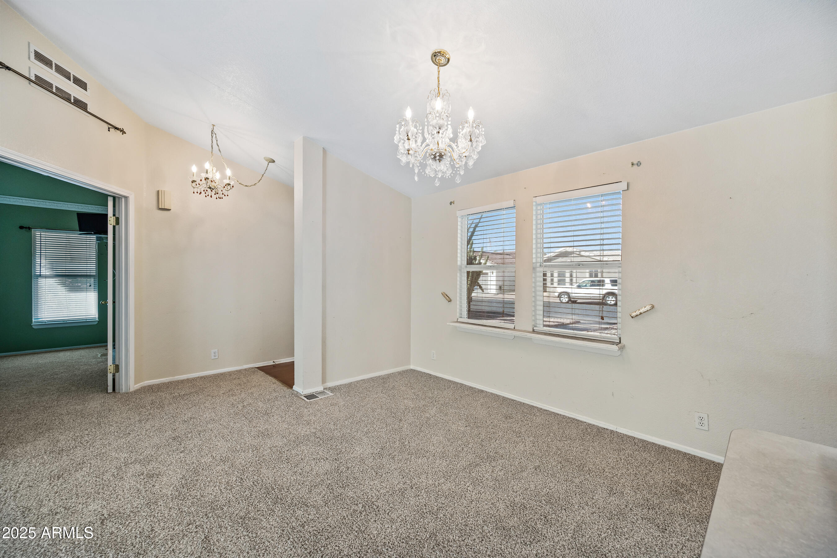 2101 South Meridian Road, Unit 49 Apache Junction, AZ 85120 - Photo 11 of 42 en empty room with windows and chandelier