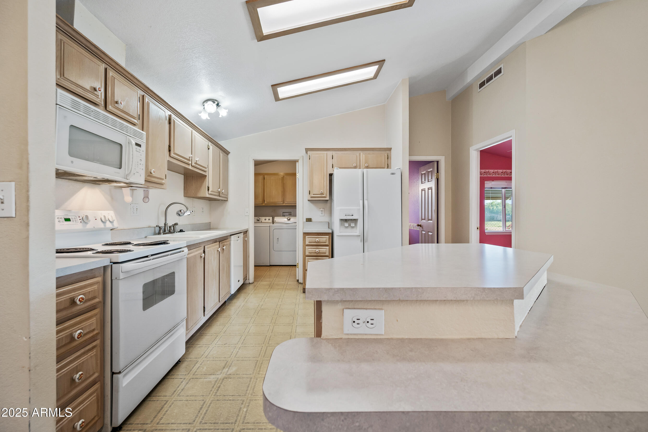 2101 South Meridian Road, Unit 49 Apache Junction, AZ 85120 - Photo 12 of 44 a large white kitchen with stainless steel appliances granite countertop a stove and a sink