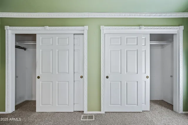 a spacious bathroom with a double vanity sink a mirror and a bathtub