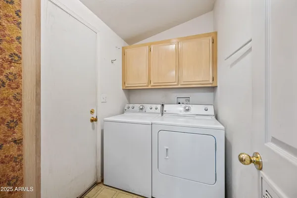a large kitchen with a table and chairs in it