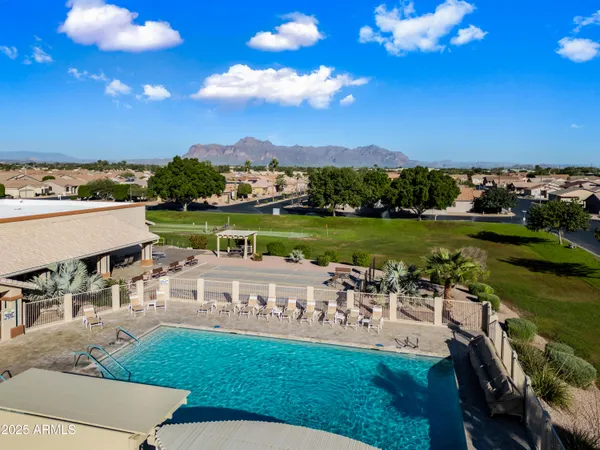 a view of a swimming pool and lounge chairs