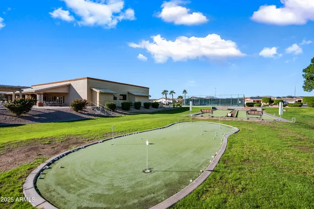 a view of a dining room with furniture a rug and wooden floor