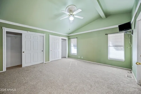a view of a livingroom with a furniture chandelier fan and windows