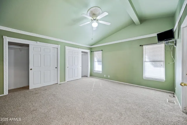 a view of a livingroom with a furniture chandelier fan and windows