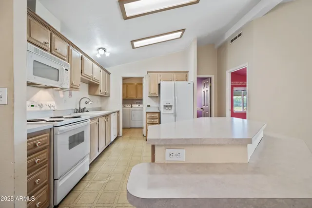 an empty room with windows and cabinet