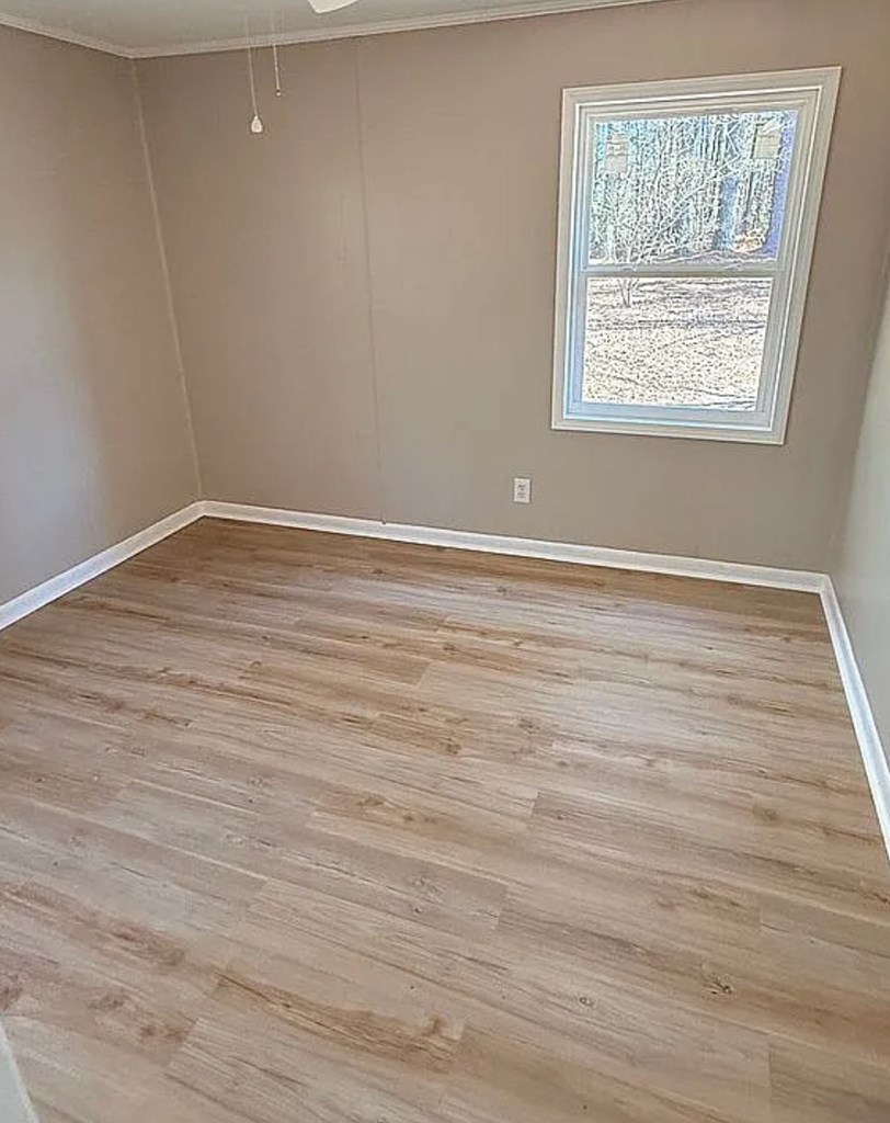 21 River Rd Drive Blairsville, GA 30512 - Photo 11 of 39 a view of an empty room with wooden floor and a window