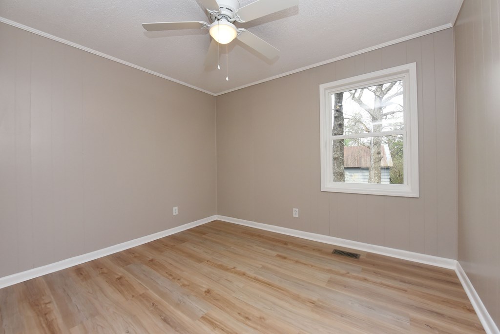 21 River Rd Drive Blairsville, GA 30512 - Photo 16 of 39 wooden floor in an empty room with a window