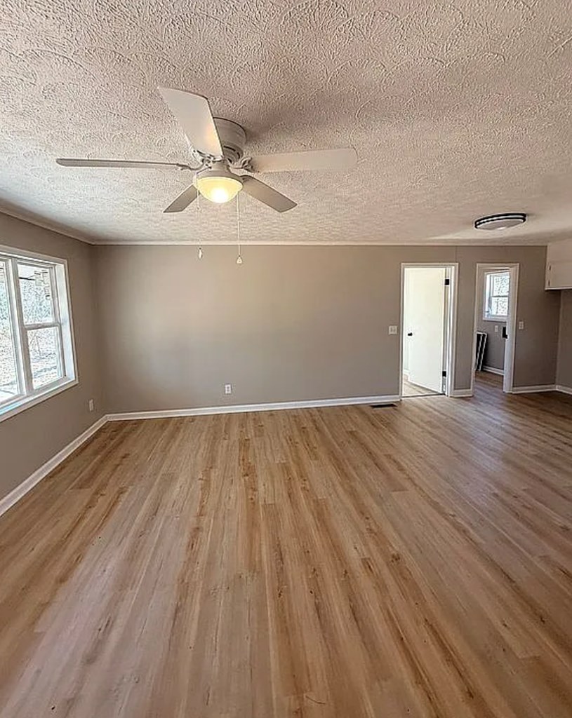 21 River Rd Drive Blairsville, GA 30512 - Photo 2 of 39 wooden floor in an empty room with a window