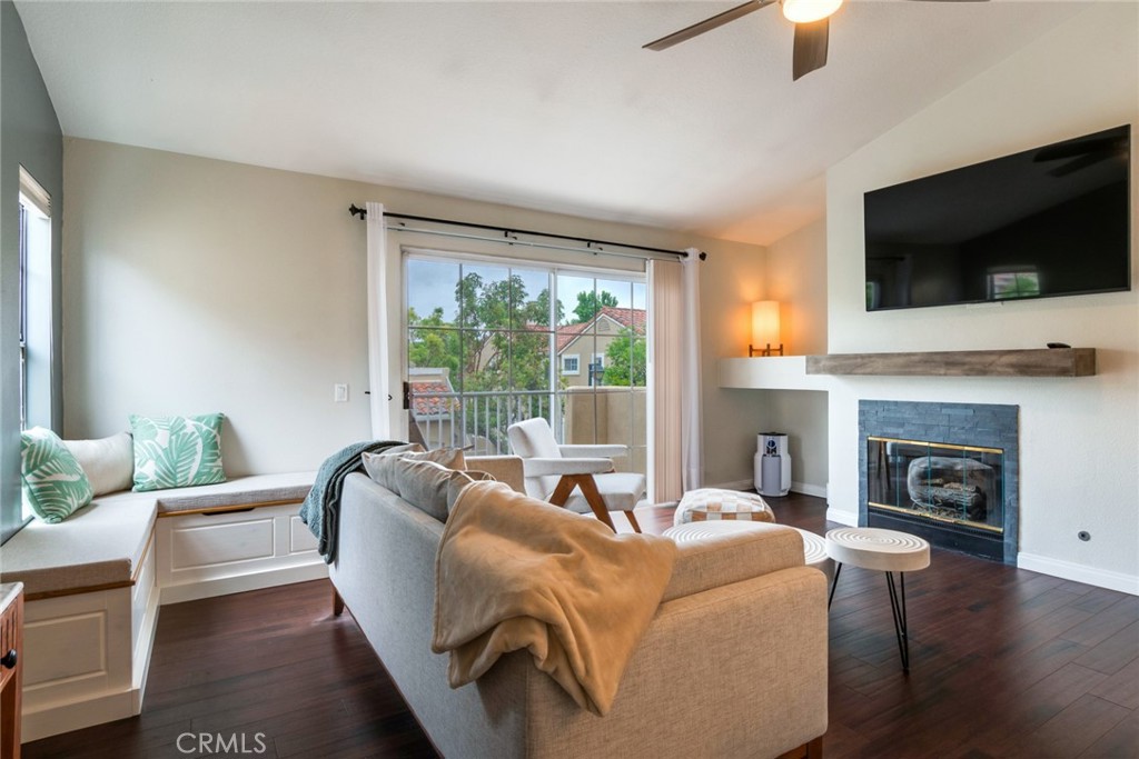 a living room with furniture a fireplace and a flat screen tv