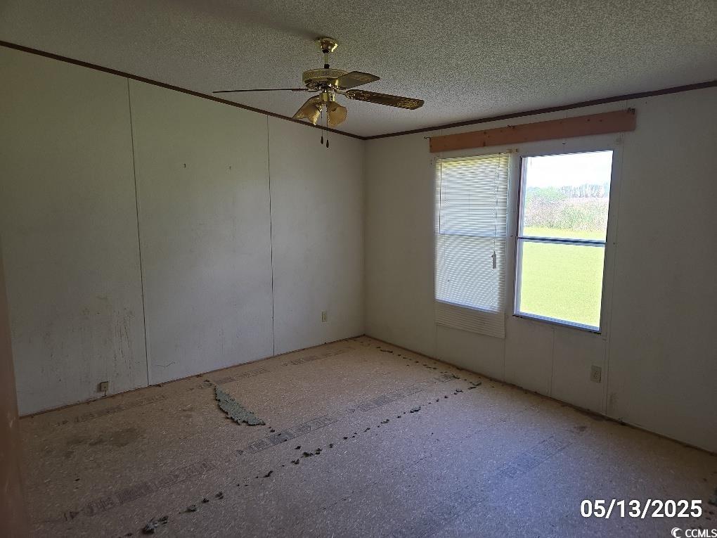 11 Lilac Lane Nesmith, SC 29580 - Photo 18 of 34 Unfurnished room with ceiling fan and a textured c