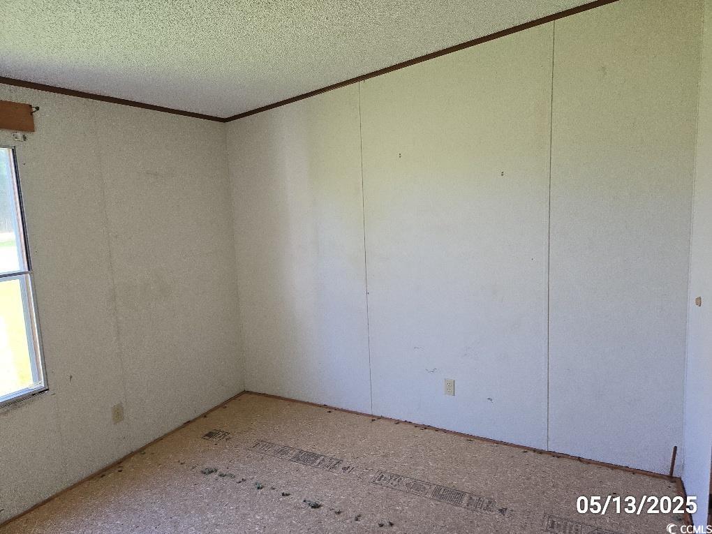 11 Lilac Lane Nesmith, SC 29580 - Photo 32 of 34 Empty room featuring crown molding and a textured
