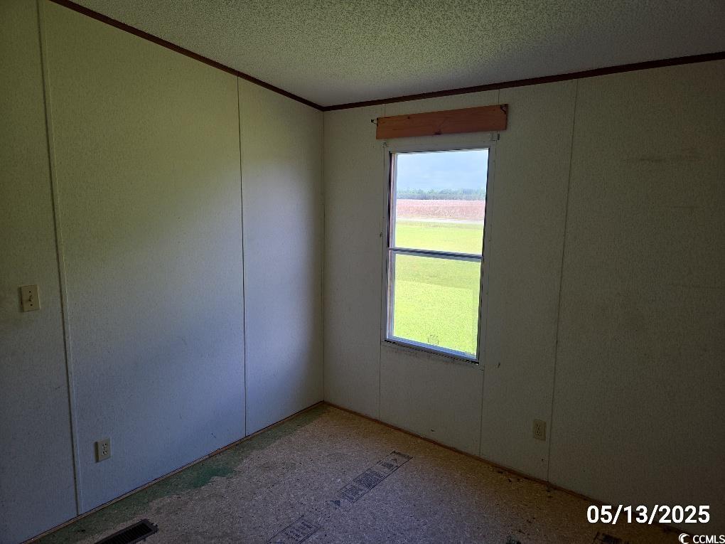 11 Lilac Lane Nesmith, SC 29580 - Photo 33 of 34 Spare room with crown molding and a textured ceili